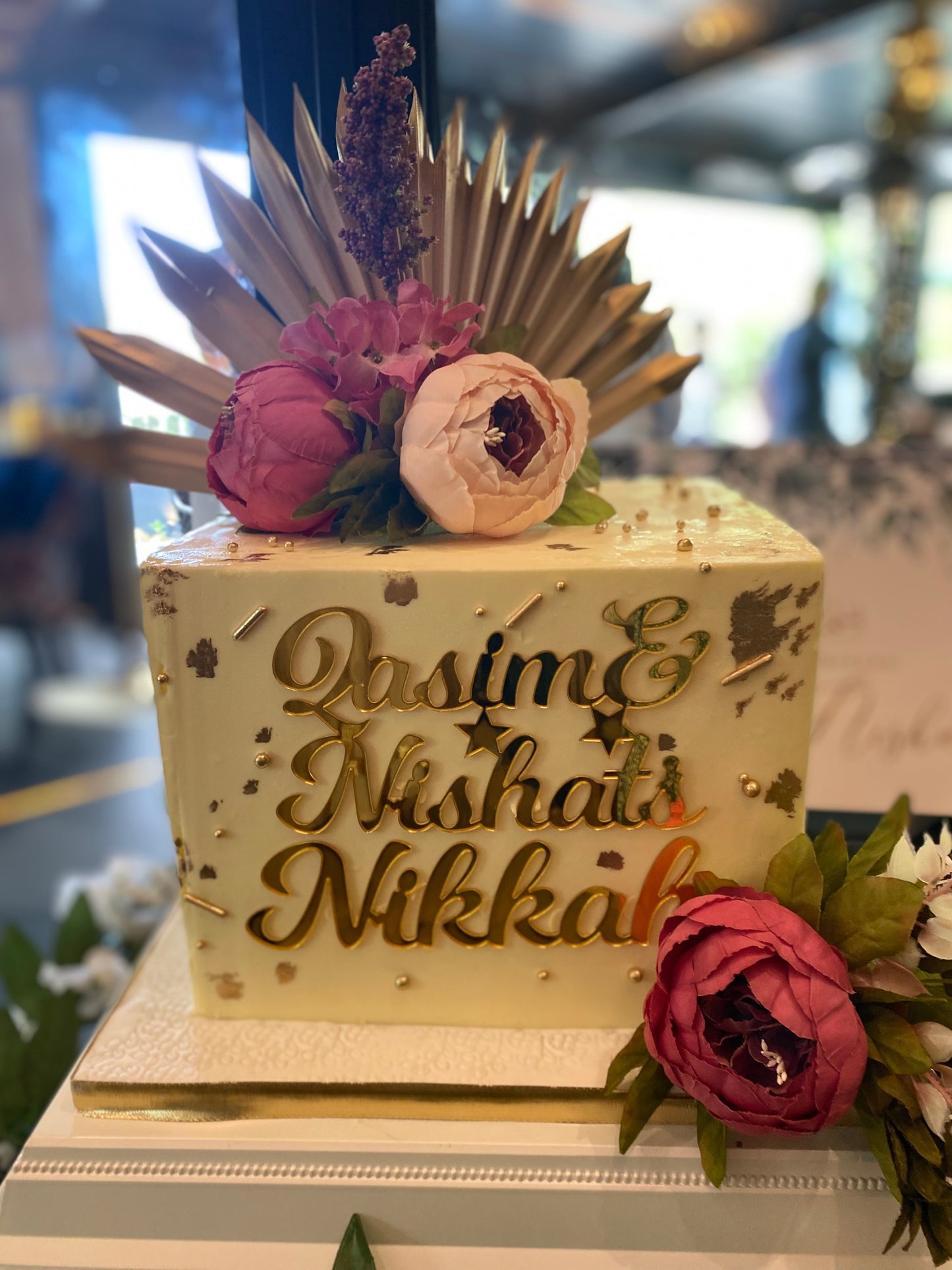 Square buttercream cake with name charm and flowers