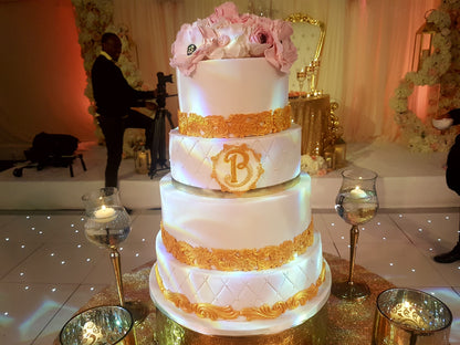 Four-tier gold and white wedding cake