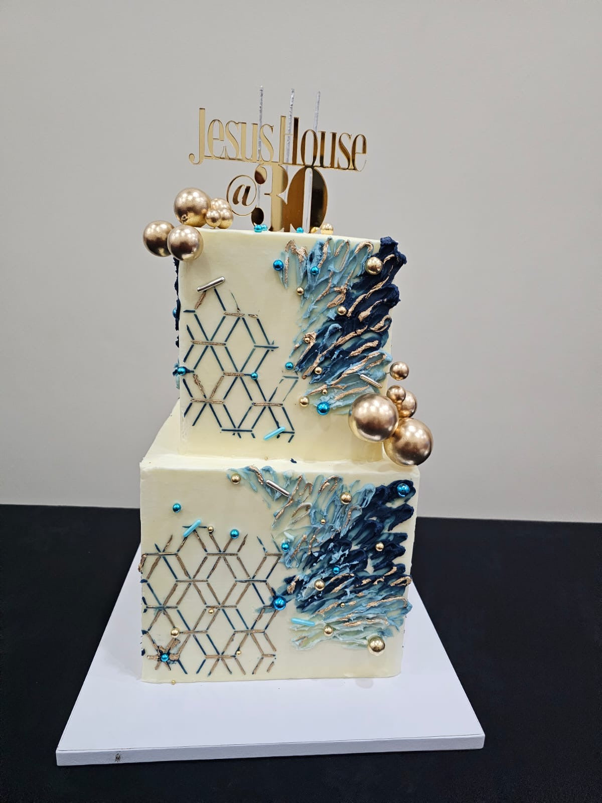 Blue square 2-tier buttercream cake with abstract design