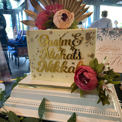 Square buttercream cake with name charm and flowers