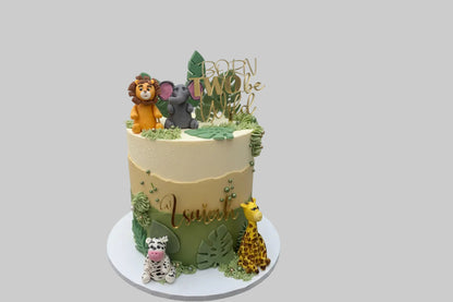 Decorative cake with animal figures and jungle-themed decorations on a white surface.